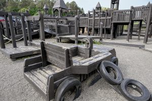 a wooden car on a wooden playground