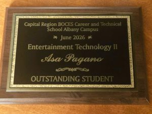 a plaque for Asa Pagano recognizes him as the Outstanding Student for the Entertainment Technology program