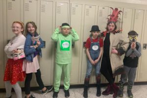 a group of students pose in front of a row of school lockers