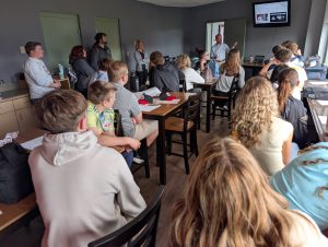 students listen to a male presenter