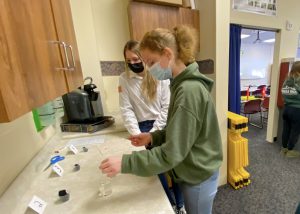 a young girl wearing a face mask participates in an experiment