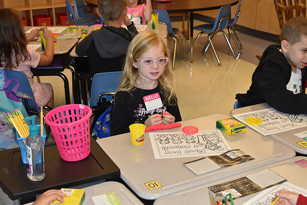 elementary students sitting at desks