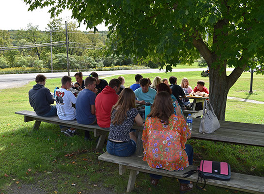 high school students sitting at picnic table