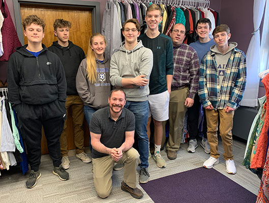 Students and staff posing as a group in Eagles Outlet