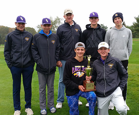 7 male golfers standing with 2 kneeling holding trophy