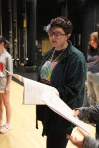 a student actor practices their lines on stage