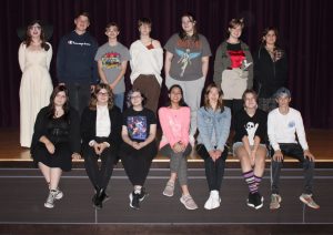 a group of young actors poses on a theatrical stage