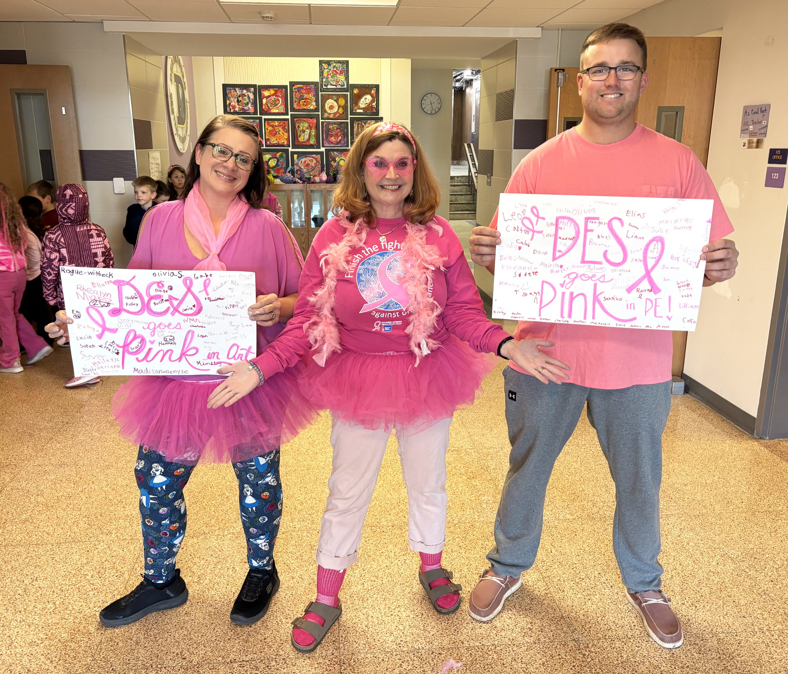 three adults wear all pink