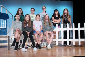 a group of crew students pose on a theatrical stage