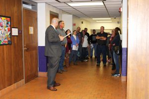 a group tours a school and visits an outdated wing of the building