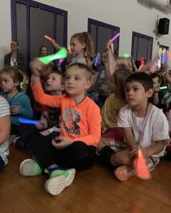students wave glow sticks in the air