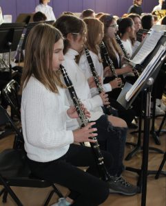 a girl plays the clarinet