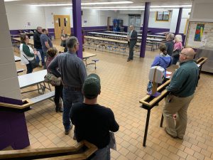 a group tours an outdated cafeteria