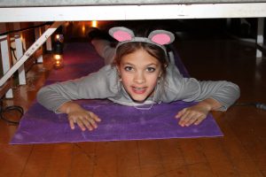 a gyoung irl is dressed up in a rat costume