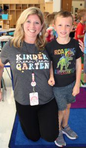 a woman wearing a t-shirt that reads "Kindergarten" stands next to a little boy wearing a similar t-shirt