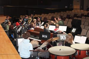 a man conducts an orchestra in a theater