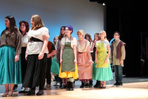 students perform a scene on a theatrical stage