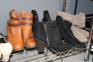 women's boots are displayed on a shelf