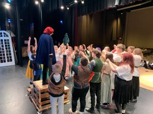 actors perform a scene on a theatrical stage