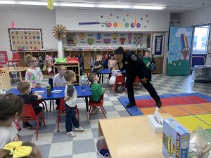 a police officer speaks to elementary students in a classroom