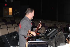 a man plays an electric bass guitar