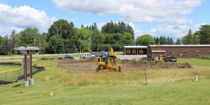 a bulldozer is shown in a construction zone with a brick building in the background