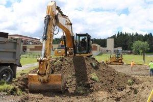 a bulldozer is shown on top of a mound of soil