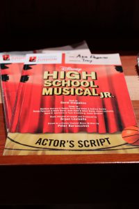 an actor's script for "High School Musical Jr" is shown backstage in a theater