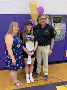 a young woman poses with her parents