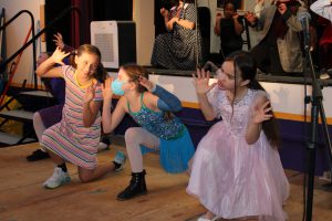 young students in costume perform scenes from a play