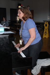 a woman plays the piano