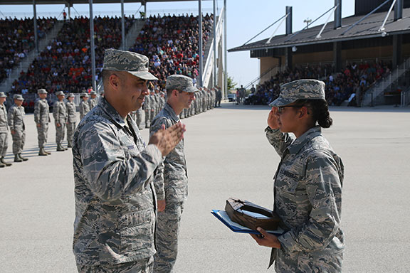 Jennifer Skeeter saluting 2 Air Force officers