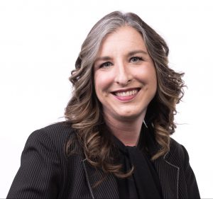 a woman wearing black in front of a white background