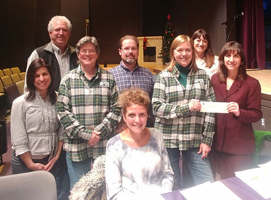 Marilyn Peterson of Rick's presents check to Board President Camille Siano Enders as BOE looks on