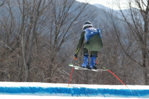 a downhill skiier jumps