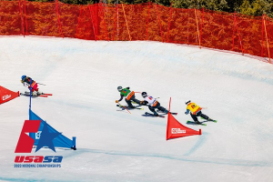 downhill skiers race each other