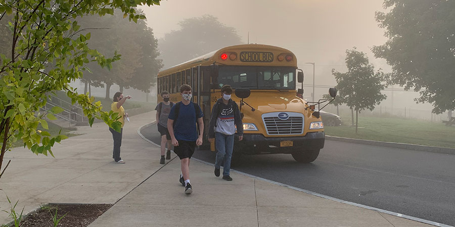 students walking from bus