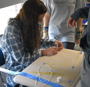 Mrs. Kanarkiewicz's Senior Seminar Class sees which team can build a spaghetti tower to support a marshmallow.