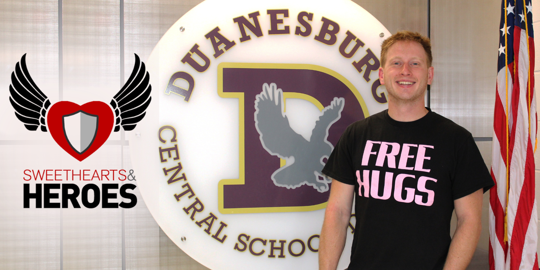 a man stands in front of a school logo, with another logo for sweethearts and heroes overlaid on top