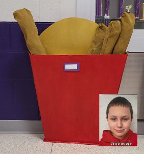 a boy is shown overlapped onto a picture of a paper mache oversized order of french fries