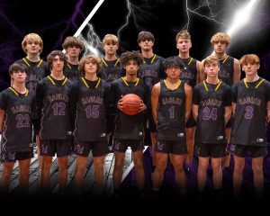 A team of teenaged boys pose holding a basketball