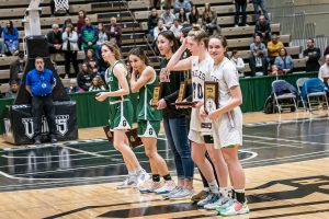 honored basketball players stand in the middle of the basketball court