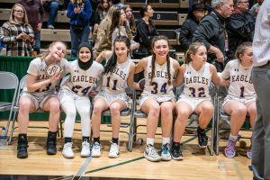 basketball athletes celebrate together on the sidelines