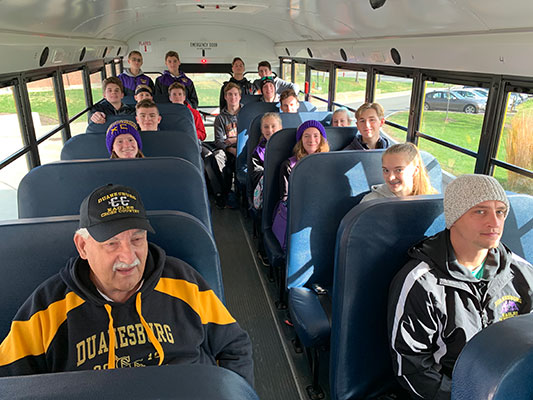 Cross country team members on school bus